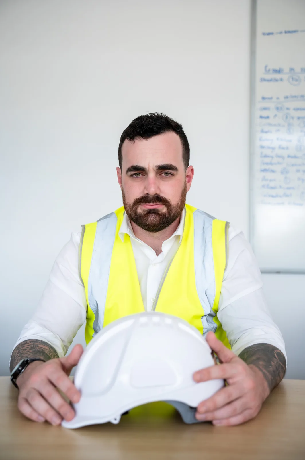 Odyssey Legal's principal in hi-vis holding a hard hat