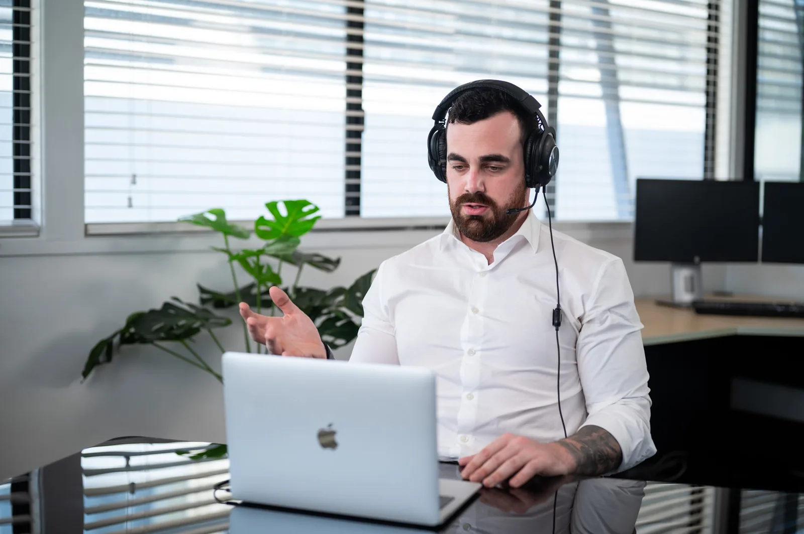 Explaining something on a headset call, hands open