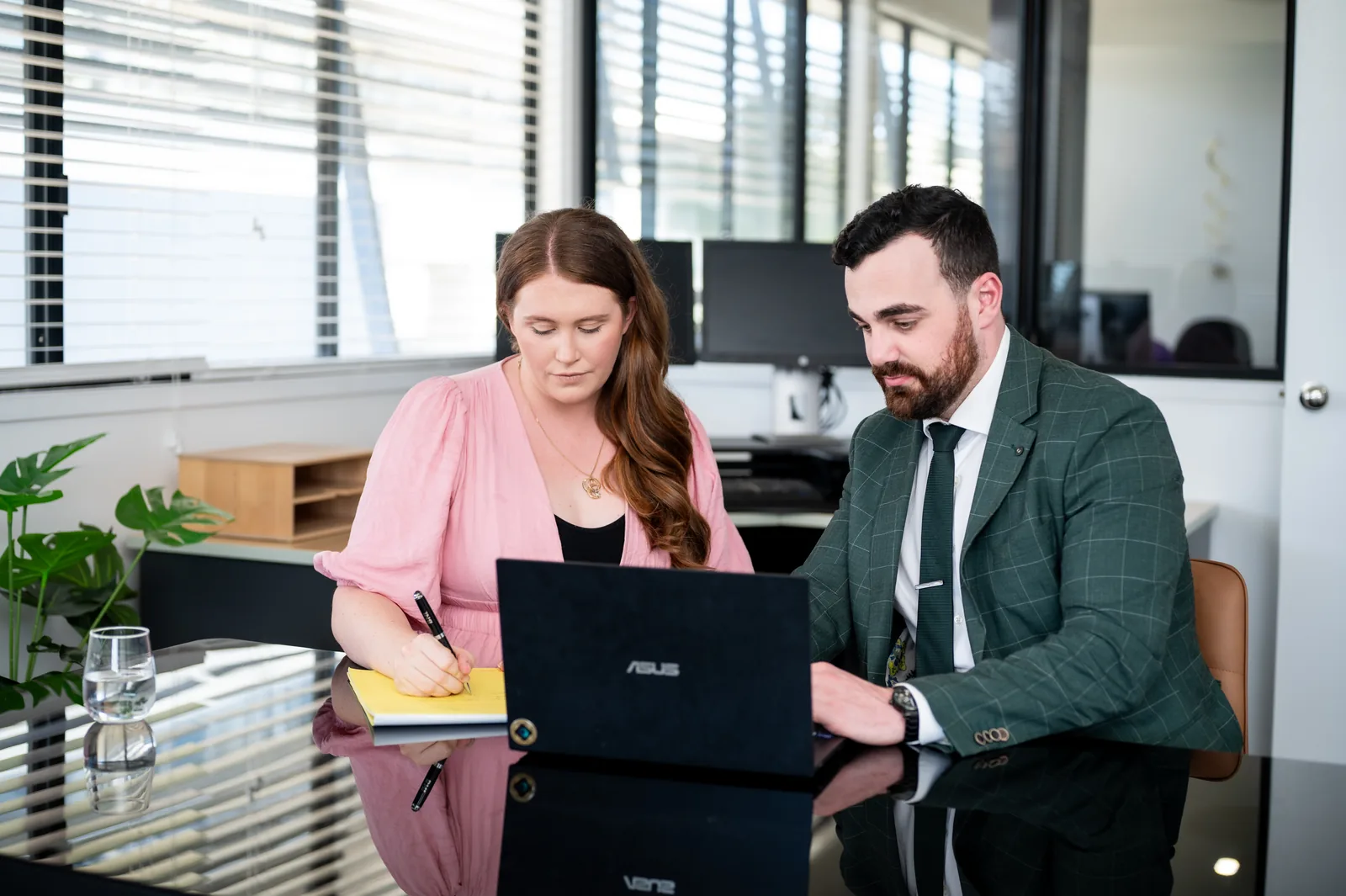 Two of the Odyssey Legal team reviewing a matter at a laptop
