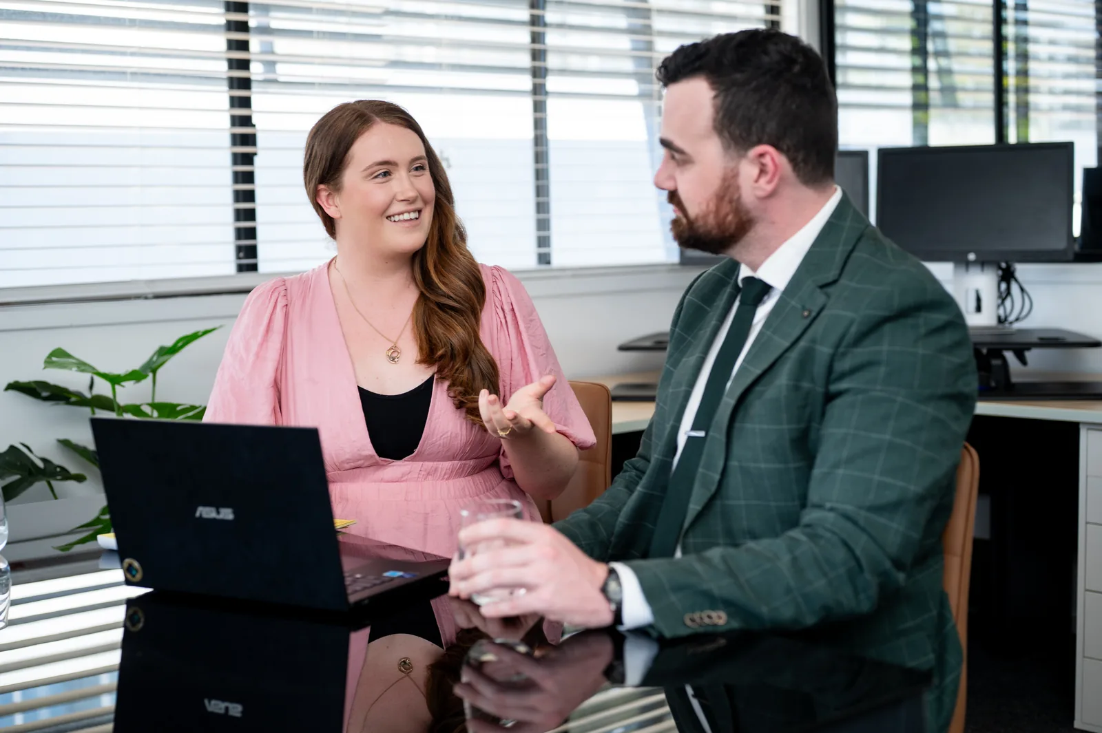 Two of the Odyssey Legal team in discussion across a desk