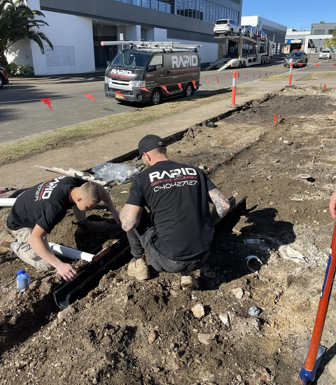 Two Rapid Service Plumbing plumbers laying new stormwater drainage