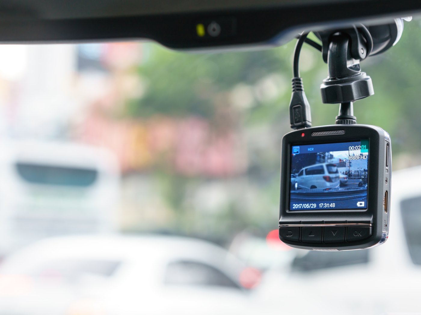 Camera unit mounted on a windscreen behind the rear-view mirror