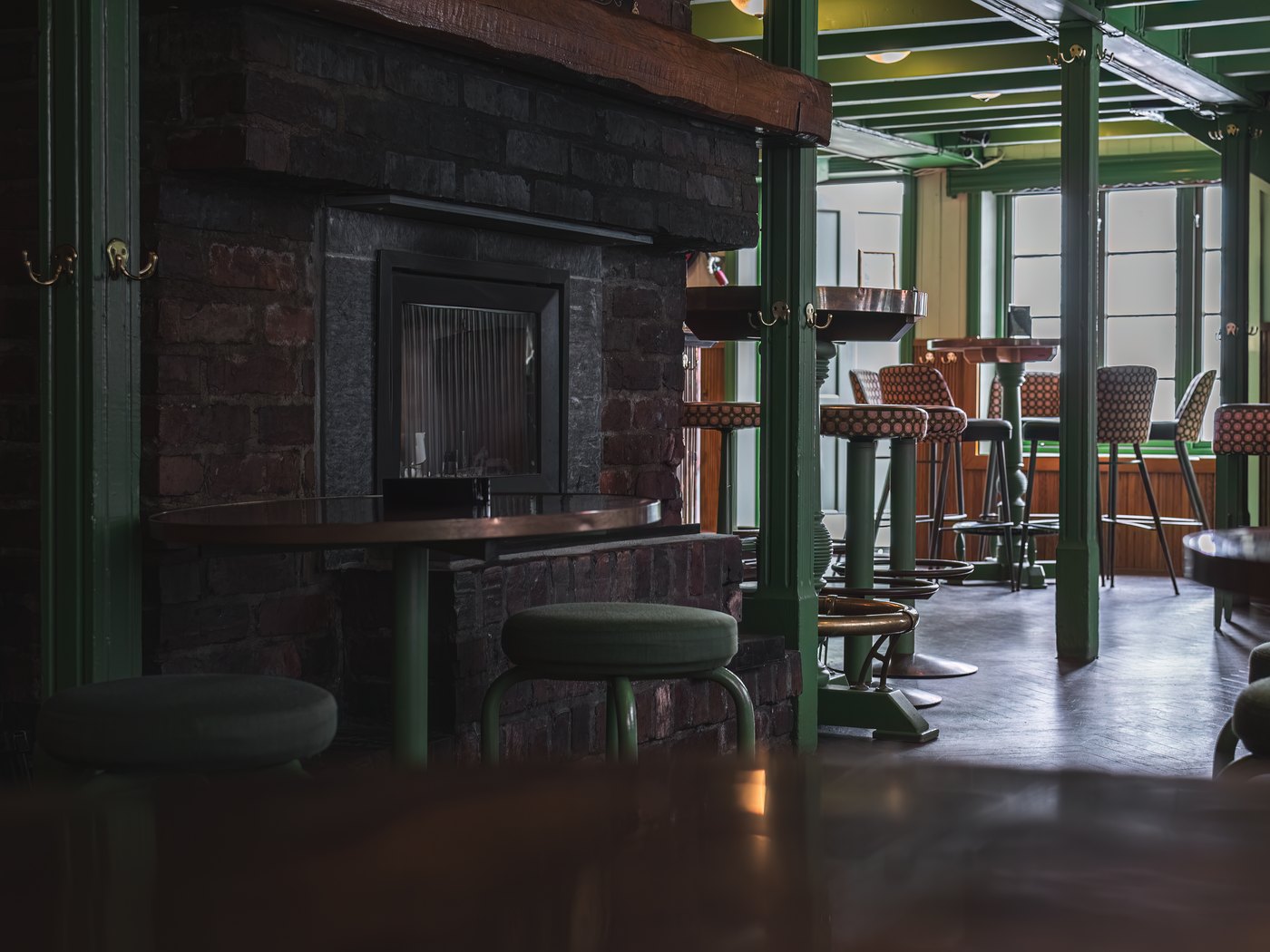 Long bar counter and rows of stools in an empty room