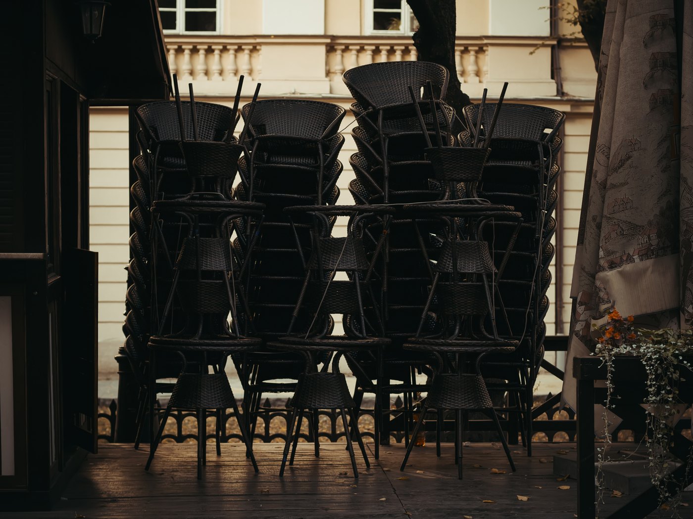 Clock behind a bar with chairs up on the tables at close