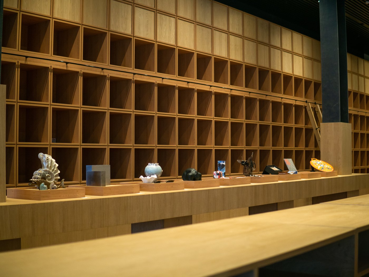 Grid of timber pigeonhole shelving rising in even layers