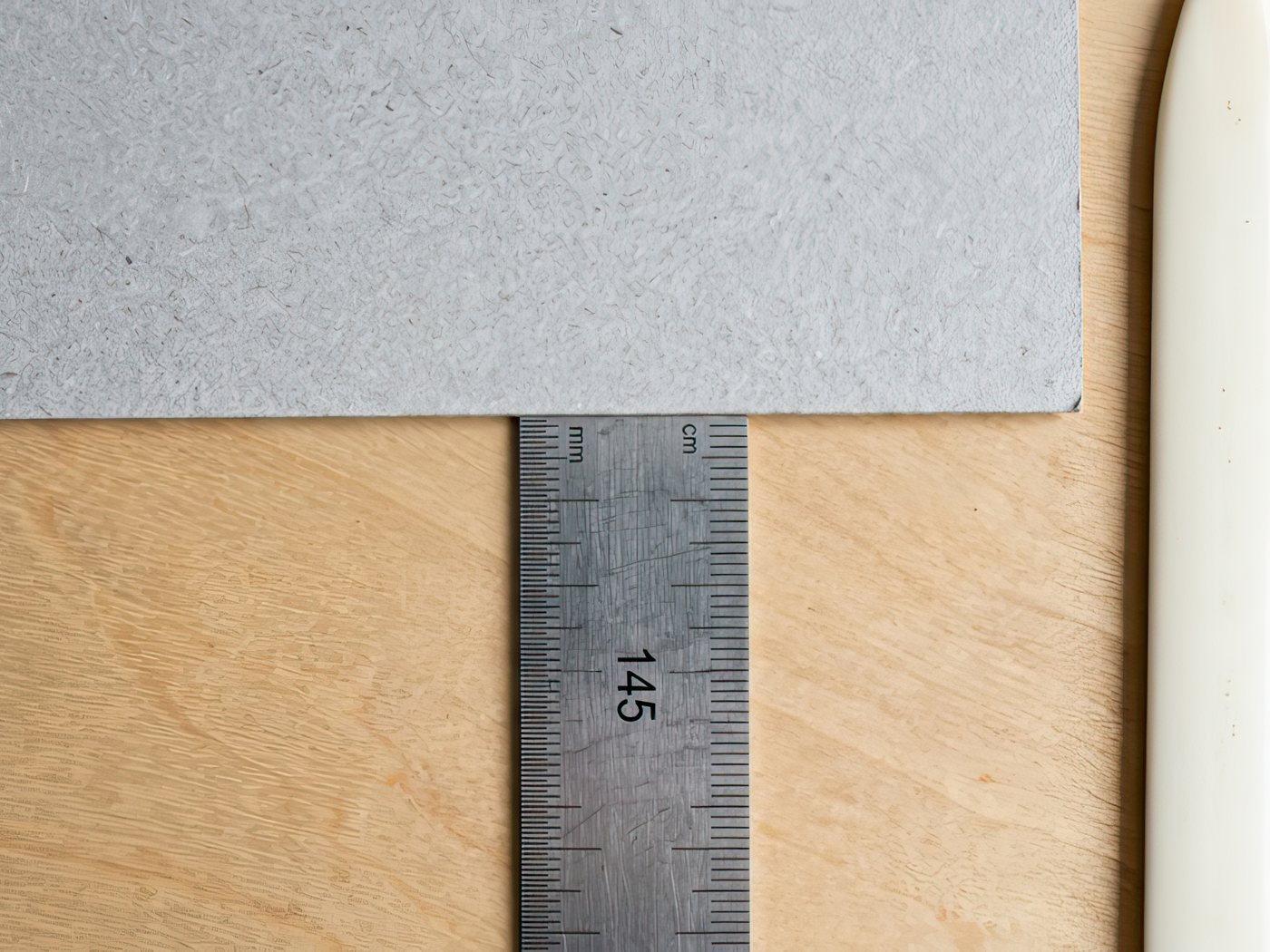 Tape measure and rule laid across a work surface