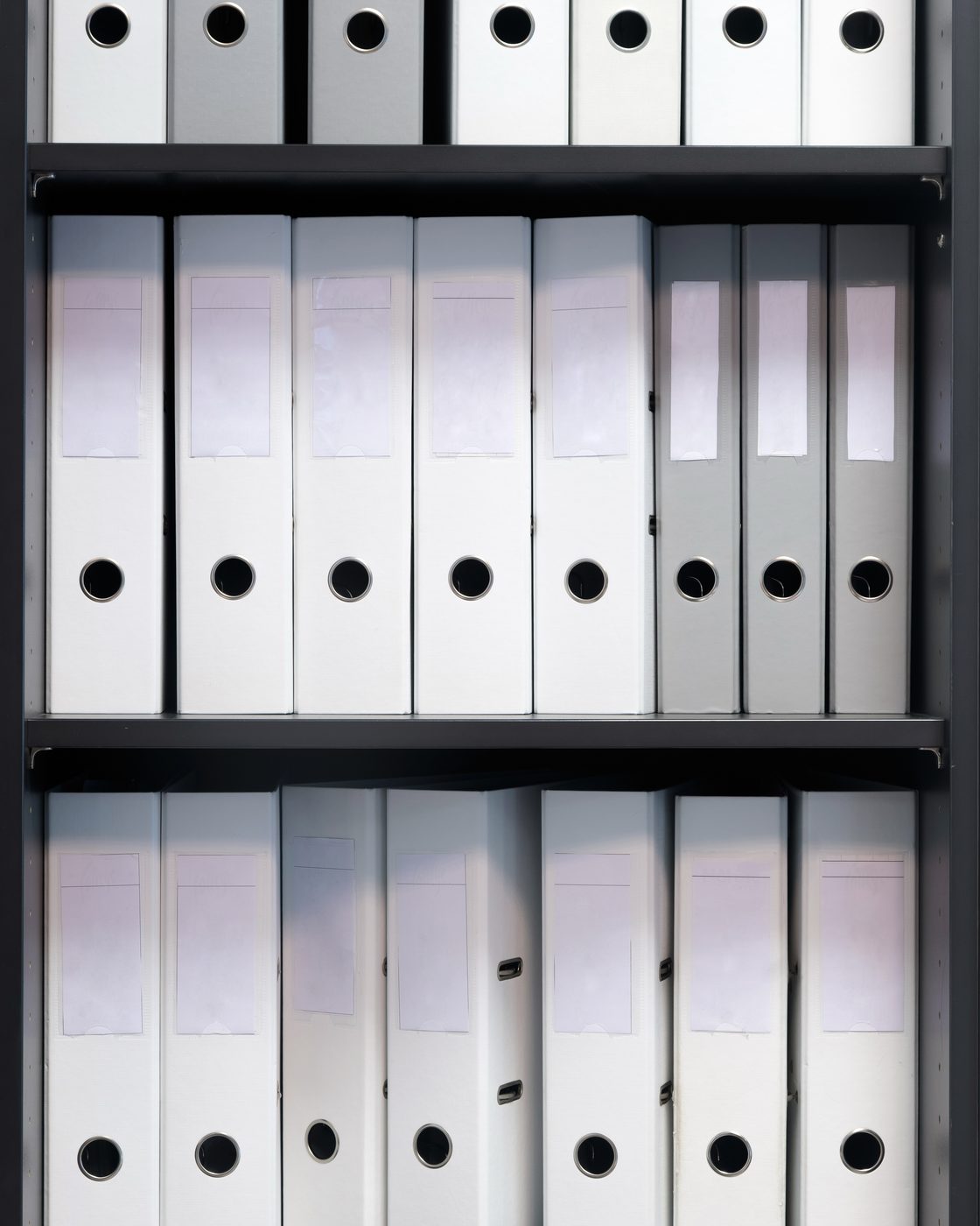 Medical practice reception counter with a computer and rows of patient record files behind it