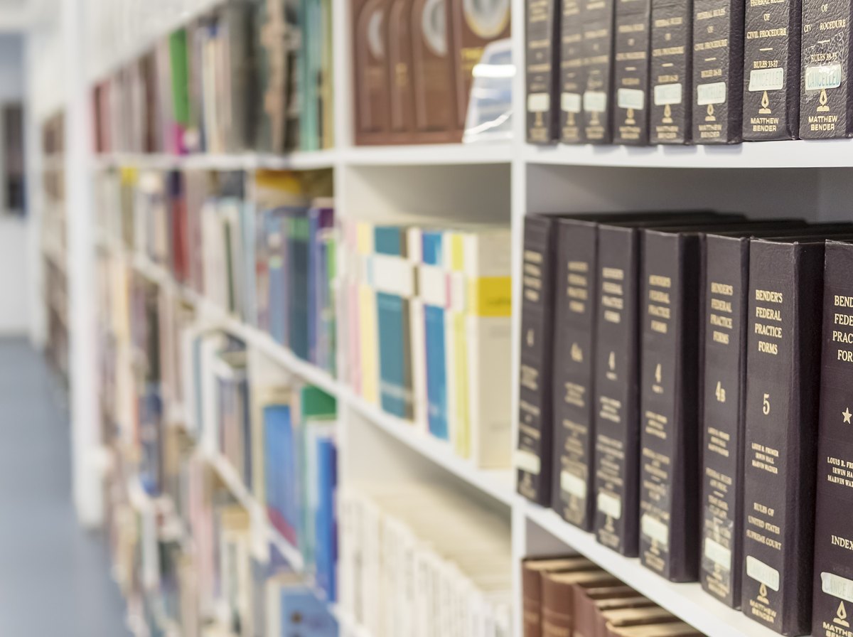 Shelves of bound law reports and legal reference volumes