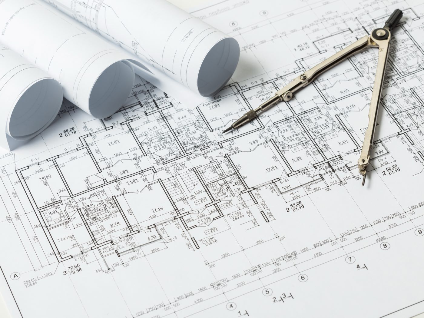 Technical drawings and a specification document laid out on a desk