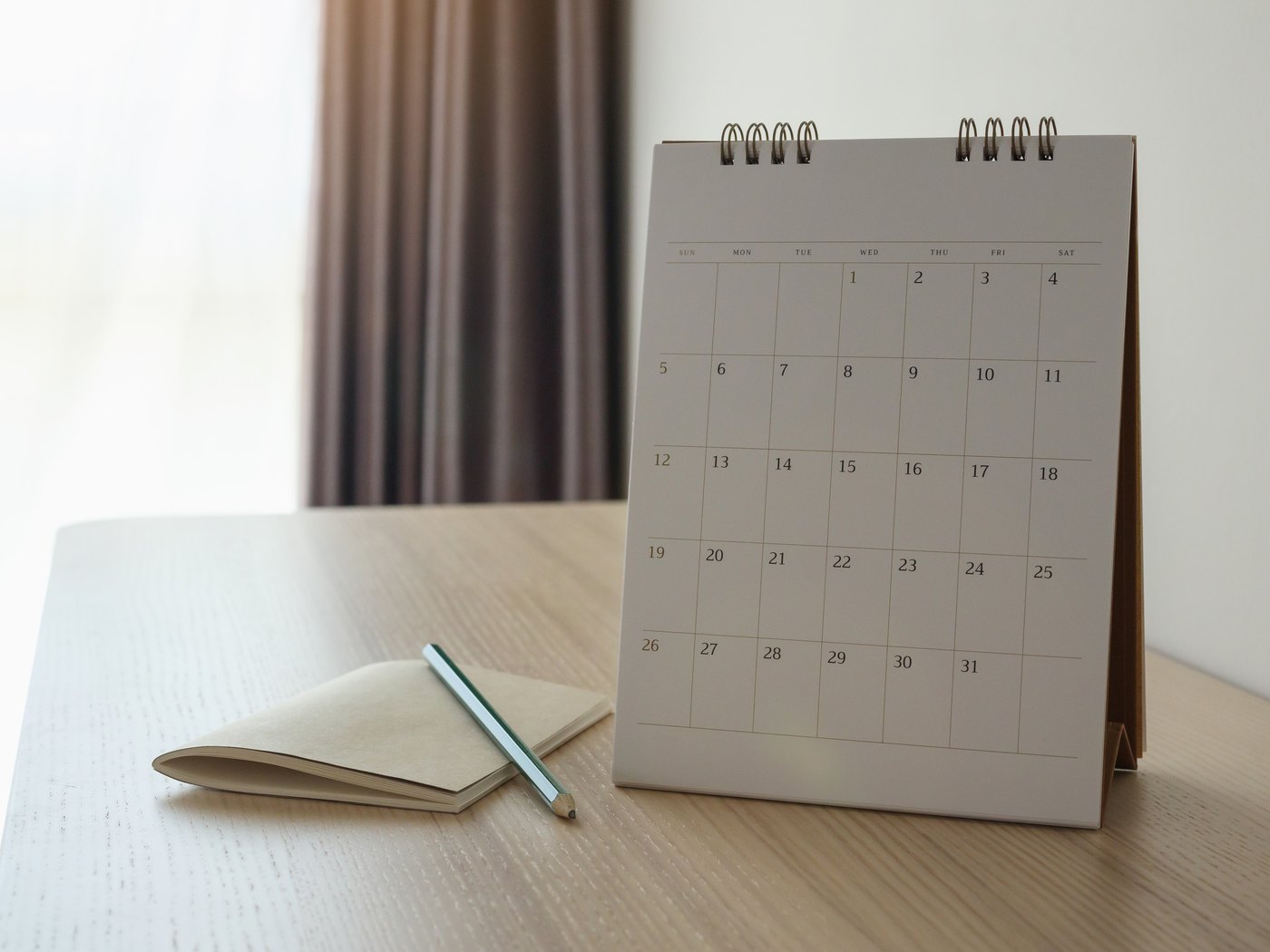 Desk calendar and a date stamp resting on a closed file