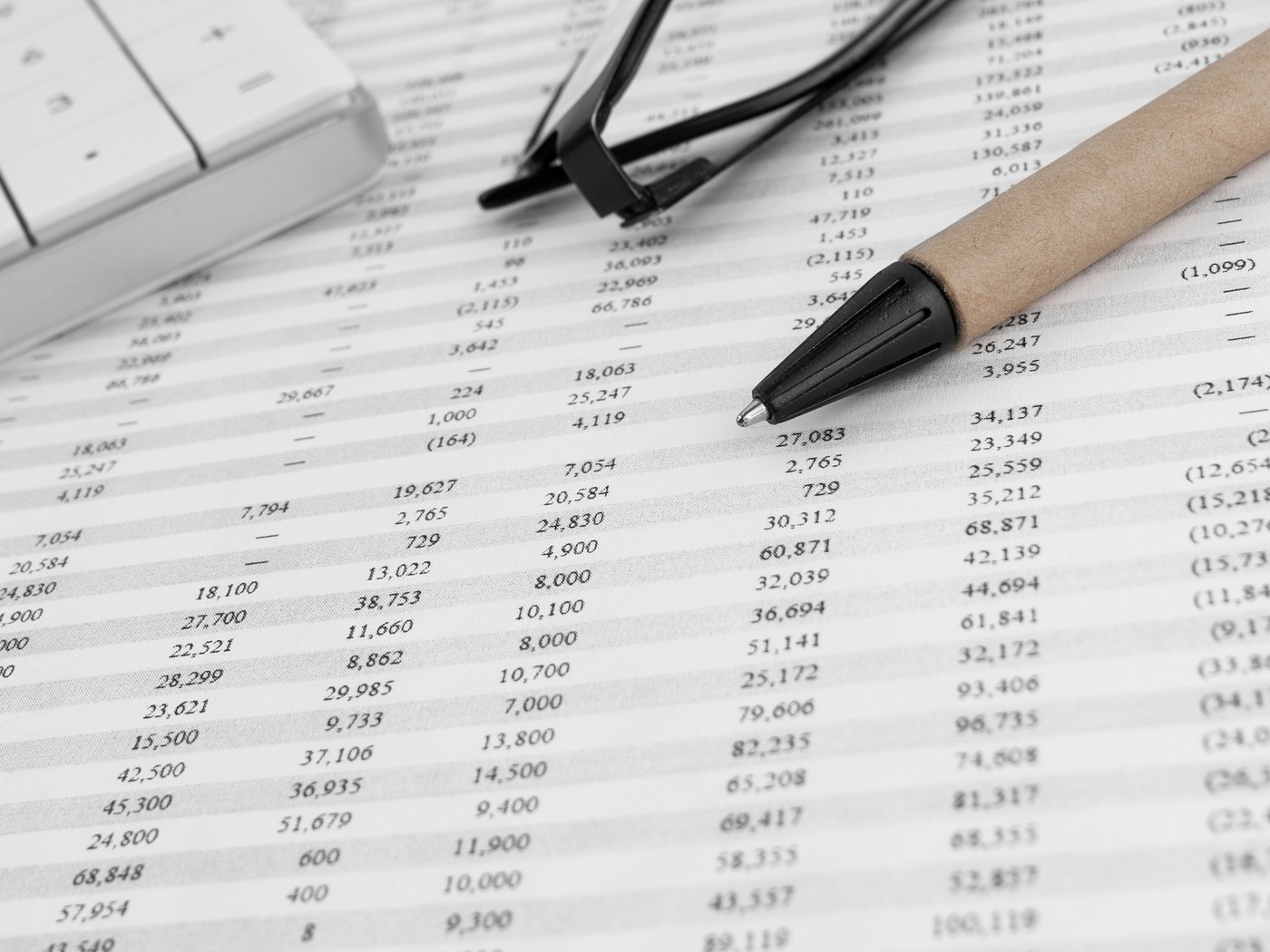 Printed asset schedule and equipment records on a clipboard