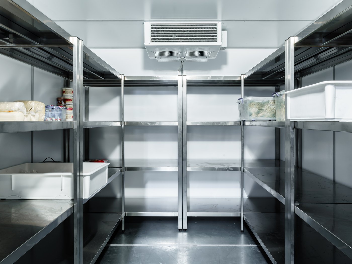 Interior of a walk-in cold room with stainless shelving and stock