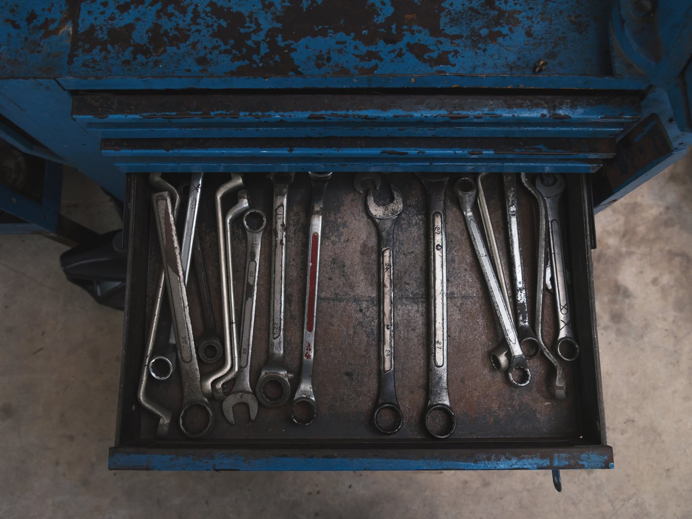 Open tool chest drawer packed with hand tools
