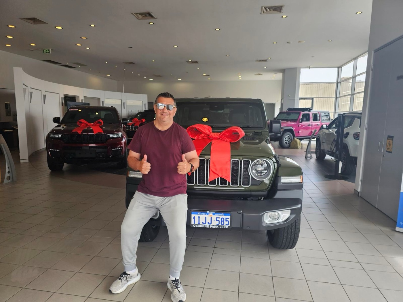 Adi collecting his Jeep Wrangler on the showroom floor