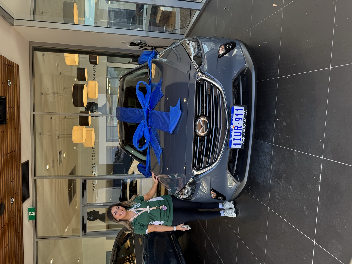 A customer beside a grey Mazda CX-3 at handover