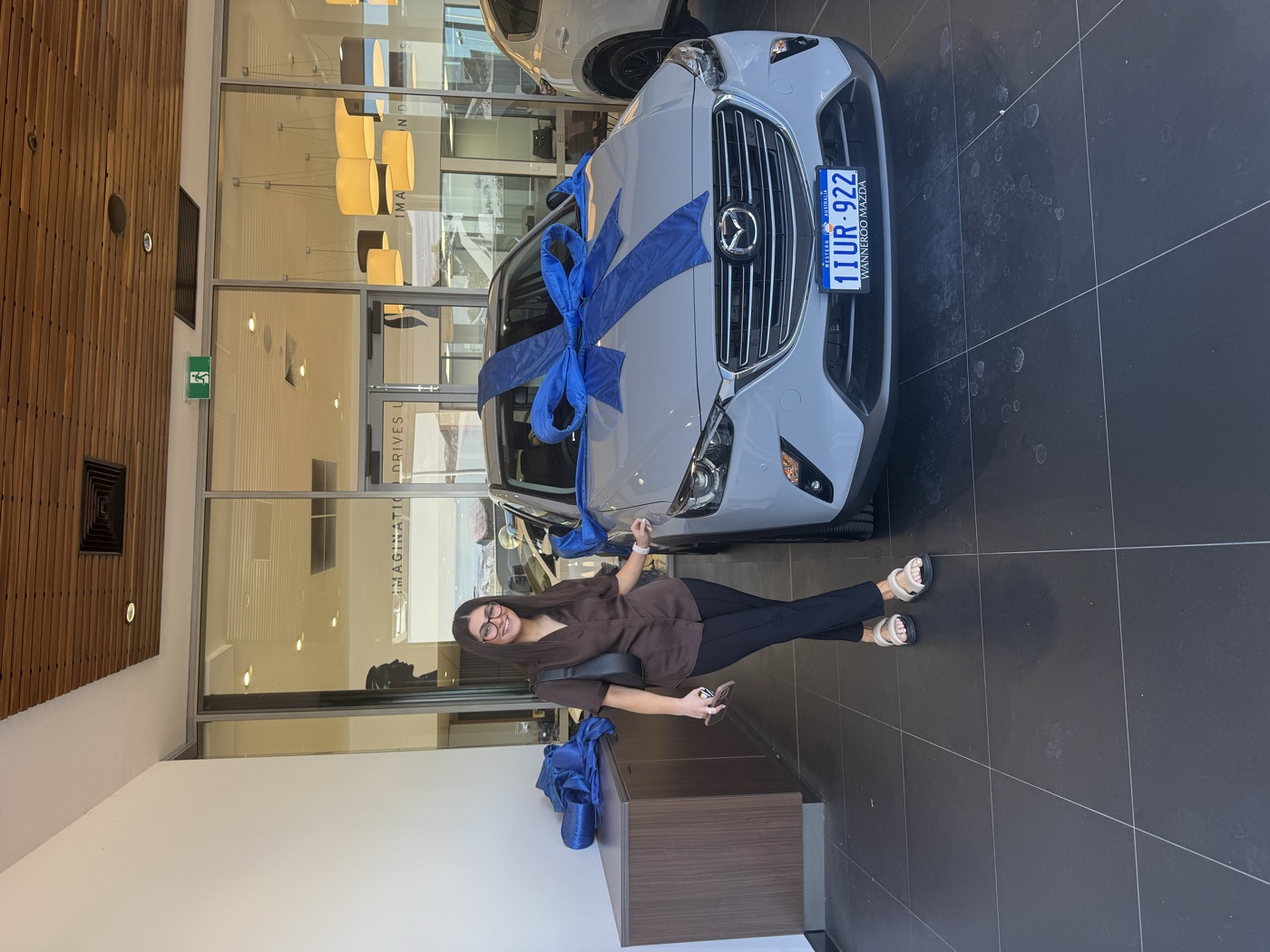 A customer taking the keys to a new white Mazda CX-3