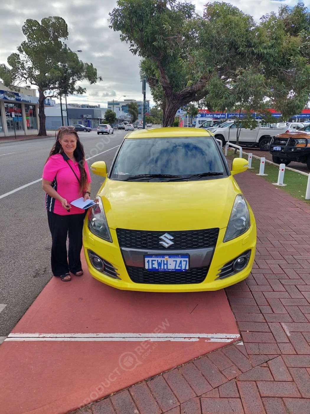 A customer with a bright yellow hatchback